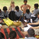 volunteer-teaching-to-make-paper-boat