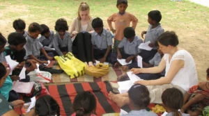volunteer-teaching-to-make-paper-boat