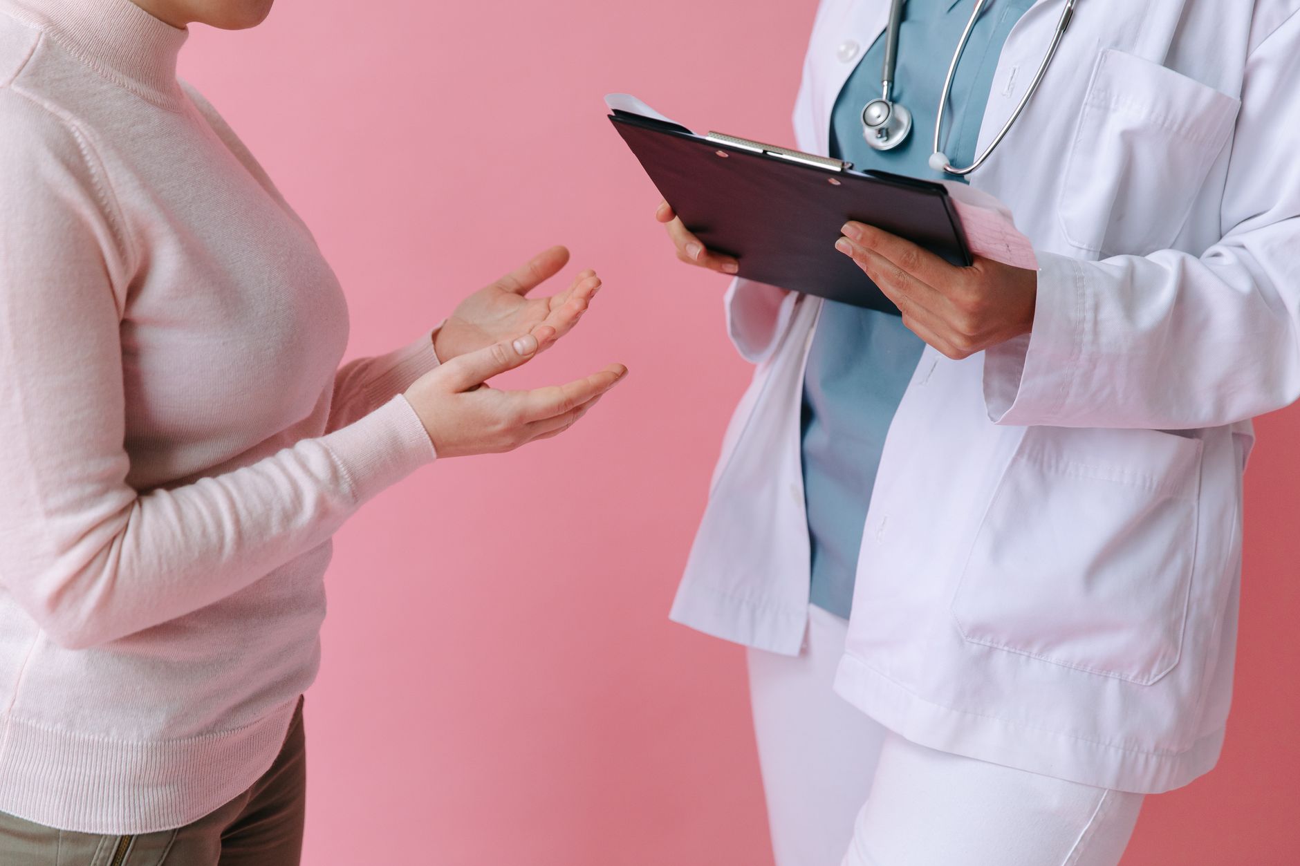 Close-up of a patient consulting a doctor with a clipboard in a medical setting. — Understanding BMI calculations and their r